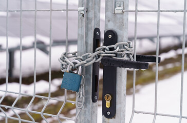 Metal gate closed with a chain to the castle