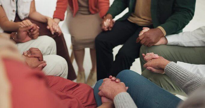 Group of people, holding hands and praying in support, faith and healing for religion, god and spiritual wellness. Community, together and circle of hope, prayer and worship for love or mental health