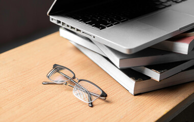 Creative Creativity Web Design desk with books, laptop and glasses on wooden background