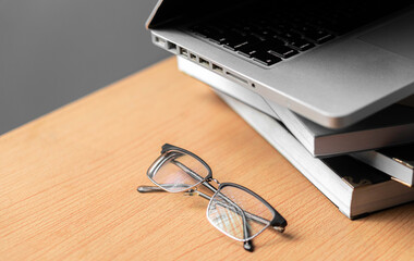 Creative Creativity Web Design desk with books, laptop and glasses on wooden background