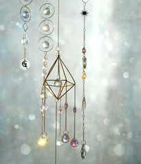 Crystal prisms on abstract blurred light natural background. Magic Ritual with crystal suncatcher....