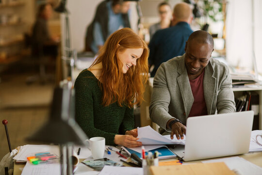 Diverse pair of architects working on a project in a modern office