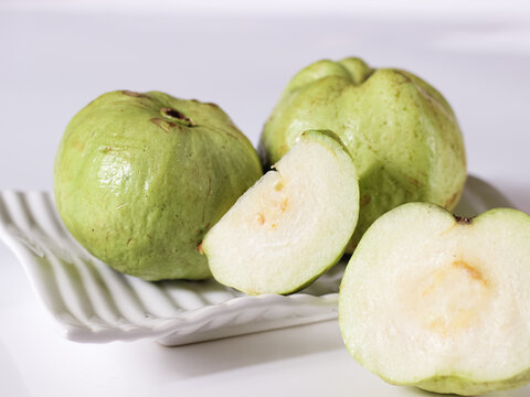 Crystal Guava (Psidium guajava) or Jambu Kristal, served in white ceramic square plate isolated in white background, copy space.