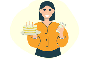 Happy young woman holding cake with candles using mobile mobile phone, isolated on plain background. Birthday concept
