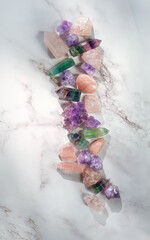 set of minerals on marble background. Fluorite, amethyst and rose quartz collection. Gemstones for...