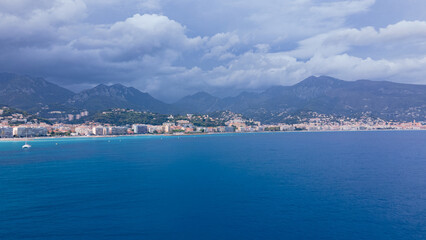 Aerial view of The French Riviera at Menton, France. Photography was shoot from a drone at a higher altitude from above the bay with the city and the mountains in the background on a stormy weather.