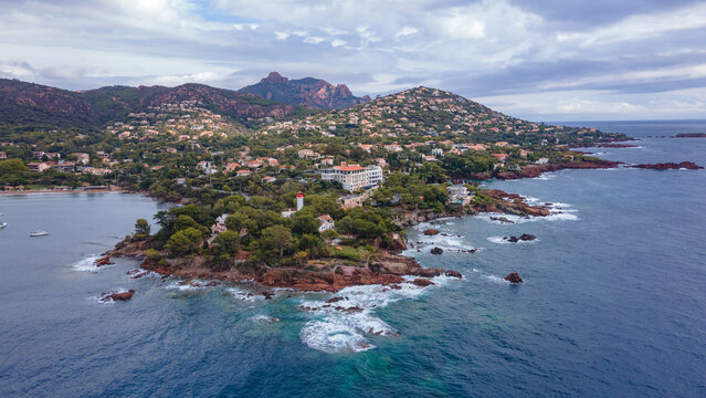 Aerial video of the Agay bay on the French Riviera. In the photography can be seen Agay lighthouse and a panorama of the bay, with mountains in the background. Photography was shot on a cloudy day.