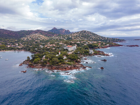Aerial video of the Agay bay on the French Riviera. In the photography can be seen Agay lighthouse and a panorama of the bay, with mountains in the background. Photography was shot on a cloudy day.