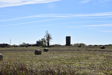 Silo and Hay Bales in a Farm Field