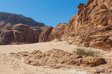 Sinai desert. Yellow and orange sandstone textured carved mountain, bright blue sky. Egyptian desert landscape. Sinai peninsula, Egypt