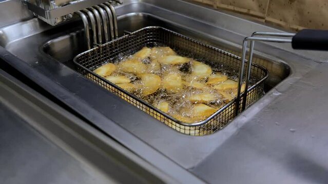 The process of frying chebureks in boiling oil. Pasties with meat fried in sunflower oil, deep-fried. Pie or cheburek is deep-fried.