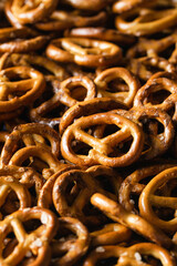 Salted mini pretzels texture background, small pretzels with salt, top view, close-up.