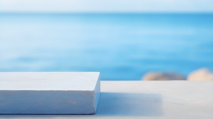 Square Stone Podium in blue Colors in front of a blurred Seascape. Luxury Backdrop for Product Presentation