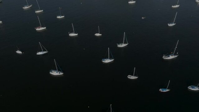 Aerial view of the Sugarloaf mountain (Pao de Acucar) in Botafogo district with sailing boat docket along the bay on the beach, Rio de Janeiro, Brazil.