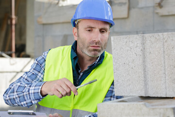 a man building a concrete block