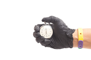 doctor's hand in black surgical medical gloves holds an activated mechanical stopwatch.