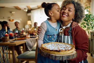 Affectionate grandmother and granddaughter with freshly baked holiday pie. - obrazy, fototapety, plakaty