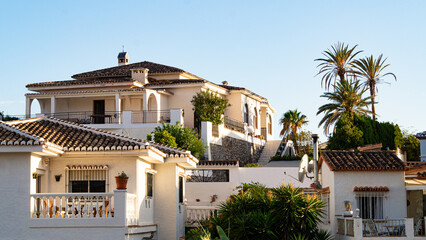 Mediterranean vacation houses with palm trees in Costa del Sol, Andalucia, Spain - obrazy, fototapety, plakaty