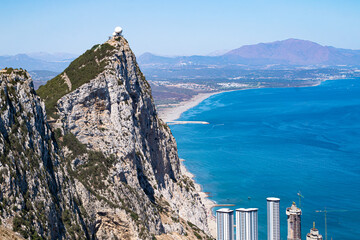 The top of the Rock of Gibraltar with the coastline and Alboran or Mediterranean sea in the background. - obrazy, fototapety, plakaty