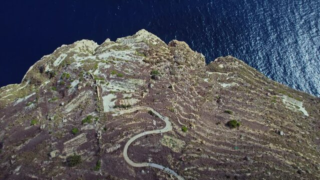 Aerial view of an off-road path along the coastline on the cliffs in Dingli, Malta.