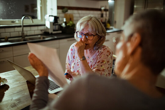 Senior lesbian couple going over bills and payments together at home