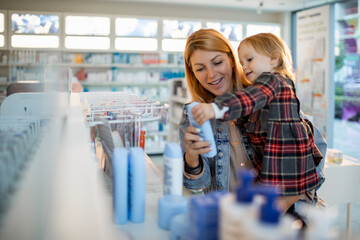 Young mother and daughter browsing the shelfs of a drugstore