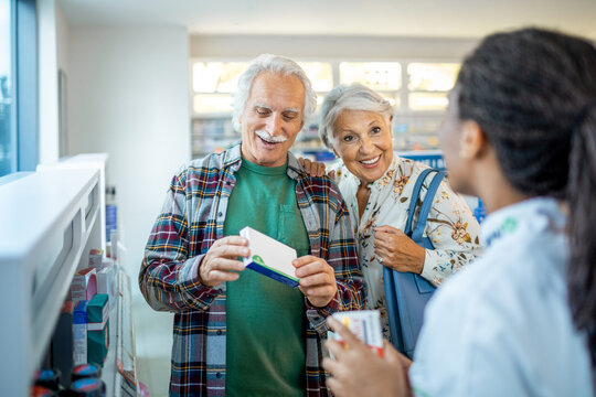 Senior couple asking for advice from a pharmacist at the drugstore