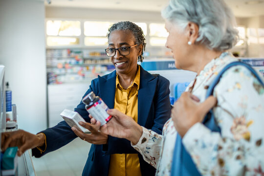 Diverse pair of senior female friends browsing the shelfs of a drugstore