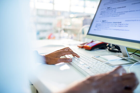Close up of a senior woman working on the the laptop at the drugstore