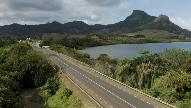 Mauritius - 21 September 2023: Aerial view of a beautiful car driving across a bridge along the coast.