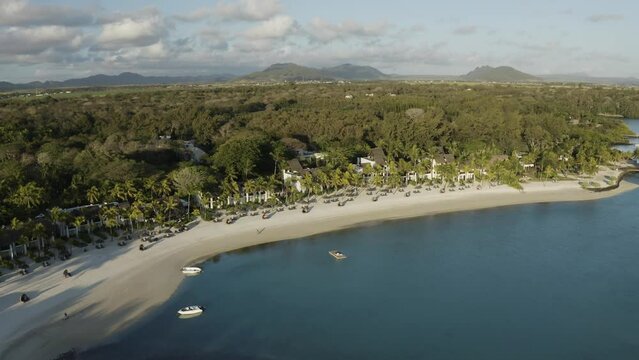 Aerial view of a luxury resort complex with bungalows on the beachfront along the coastline, Ilot Lievres, Flacq, Mauritius.