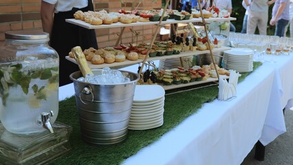 Catering on a banquet table with appetizers-canapes in a restaurant or hotel. Snacks on the table, catering concept. buffet food set for corporate day celebration.