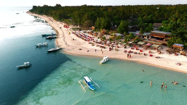 Aerial view of a catamaran with sailboats along the coastline on Gili Air Island, Karang Petang town, Bali, Indonesia.