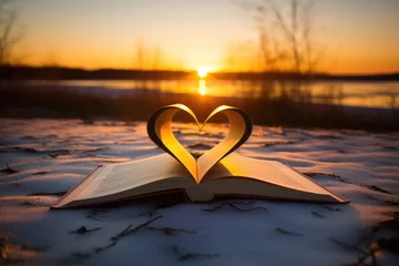 Keuken spatwand met foto A heart-shaped book resting on a snowy landscape © pham