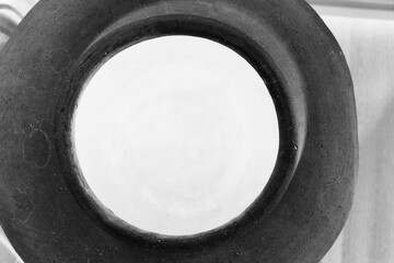 A top view of a ceramic pot in black and white film negative.