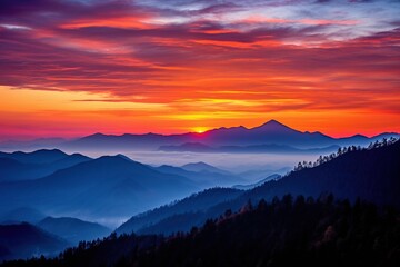 Mountain range silhouetted against a vibrant sunset