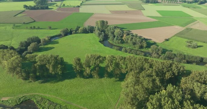 Aerial view of meandering river Roer surrounded by trees and farmland, Paarlo, Sint Odilienberg, Limburg, Netherlands