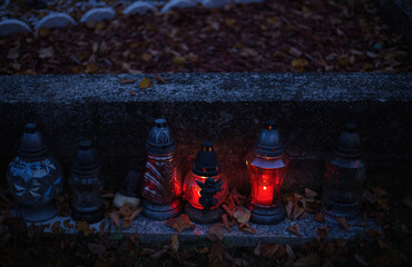 Votive candles lantern burning on the graves in Slovak cemetery at night time. All Saints' Day. Solemnity of All Saints. Hallows eve. 1st November. Feast of Saints. Hallowmas. Souls' Day in Slovakia