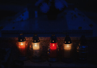 Votive candles lantern burning on the graves in Slovak cemetery at night time. All Saints' Day. Solemnity of All Saints. Hallows eve. 1st November. Feast of Saints. Hallowmas. Souls' Day in Slovakia