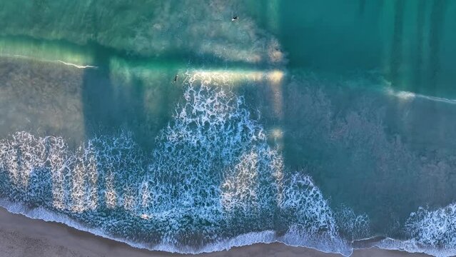 Aerial view of people doing surf waiting for waves along Trigg Beach in Perth, Western Australia, Australia.