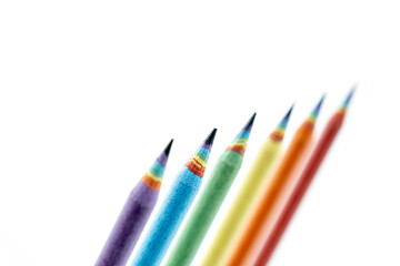 Fototapeta premium Set of Colored Pencils Made by Recycled Paper arranged on white background. Environmentally friendly stationary supplies