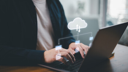 Man typing on computer laptop while woking with document files in online cloud based storage...