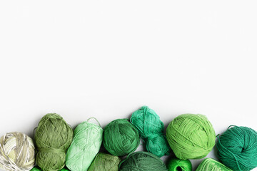 Creative layout made of green threads for knitting on a gray background with place for your text....