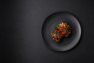 Delicious juicy fried chicken in teriyaki sauce with salt, spices, herbs and sesame seeds