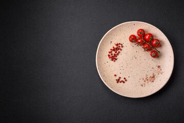 Empty ceramic plate on a dark textured background. Preparing kitchen utensils