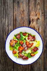 Vegetarian style caesar salad on wooden background.