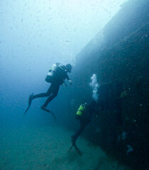 divers exploring a sunken ship