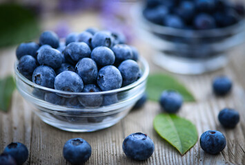 blueberries in a bowl on wooden background