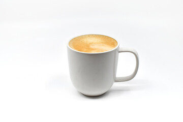 Mug of hot frothy coffee isolated on a plain white background. Copy space.