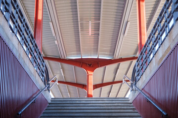 Fototapeta premium A staircase in a train station connects an underground passage with the upper platforms.